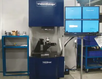 a machine is sitting in a room next to a computer monitor .