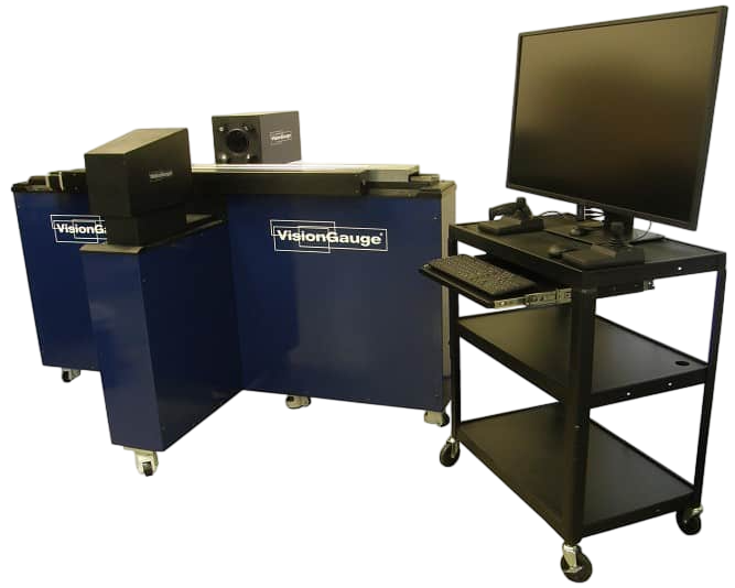 a vision gauge machine sits next to a computer