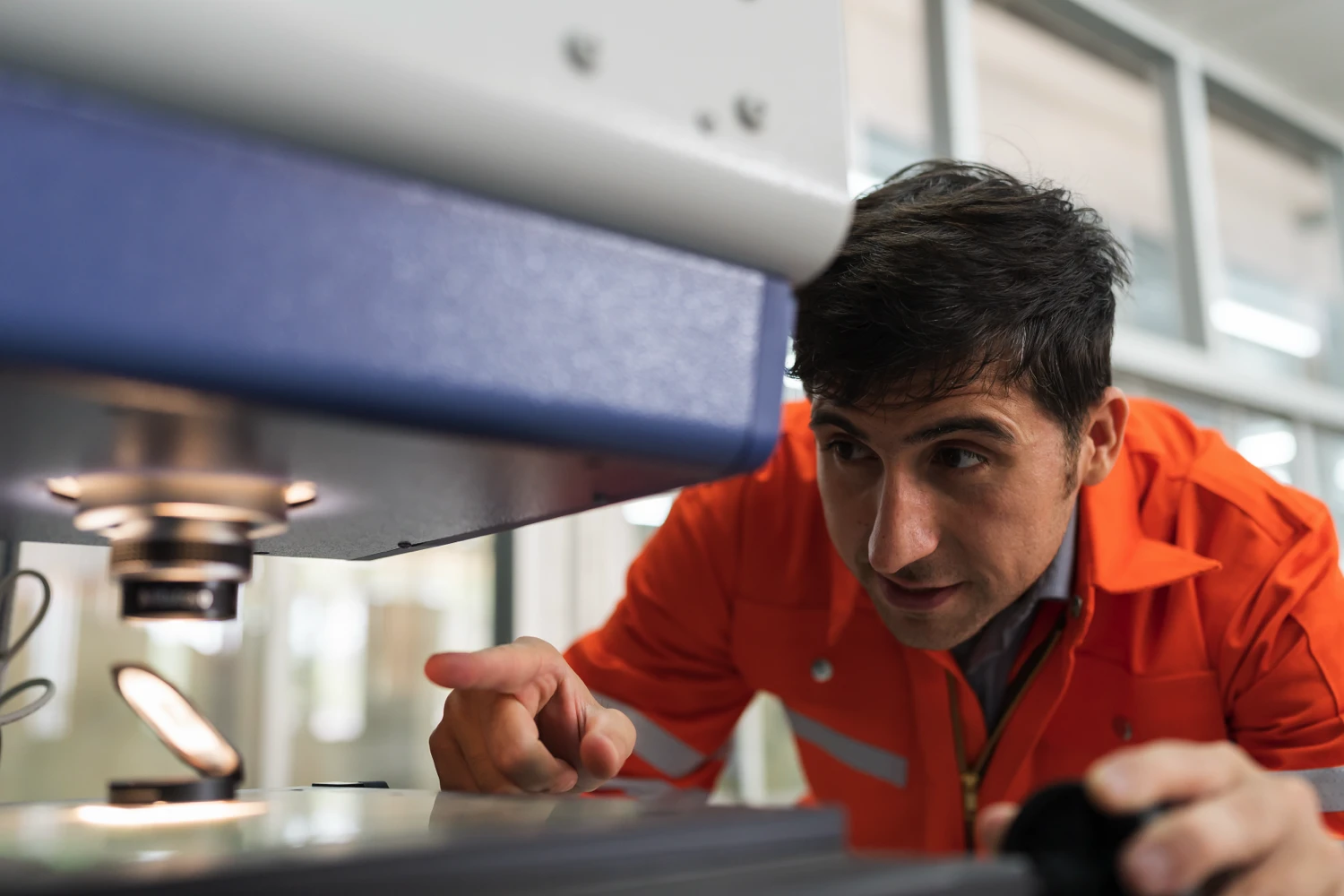 operator using a traditional optical comparator to inspect a part