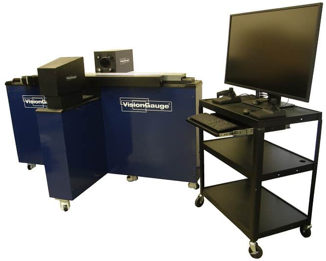 a visiongauge machine sat next to a computer on a tall black stand