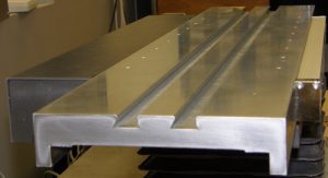 Hard chrome plated X-axis stage, made of hardened tooling steel and with dual standard dovetail grooves for easy part fixturing on a Digital Optical Comparator
